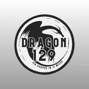 May include: Black and white round patch with a dragon silhouette and the text "Dragon 129 318 Curves in 11 Miles".