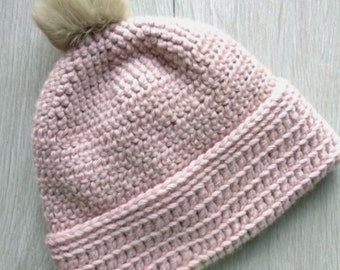 Warm pink hat with a lining and a fluffy pompom. Handmade