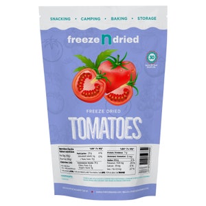 May include: A package of freeze-dried tomatoes. The package is light purple with the words "freeze n dried" and "freeze dried tomatoes" in white. The package features illustrations of whole and sliced red tomatoes with green leaves. The package also includes nutritional information.