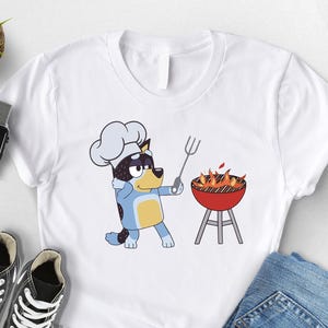 BBQ Dad Shirt, Funny Father’s Day Gift, Cartoon Blue Dog Grill‑Master Tee, Backyard Barbecue Chef T‑Shirt, Cool Dad Cooking Tshirt, Dad Tees