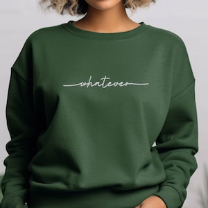 May include: A dark green sweatshirt with the word "whatever" written in white cursive on the front.