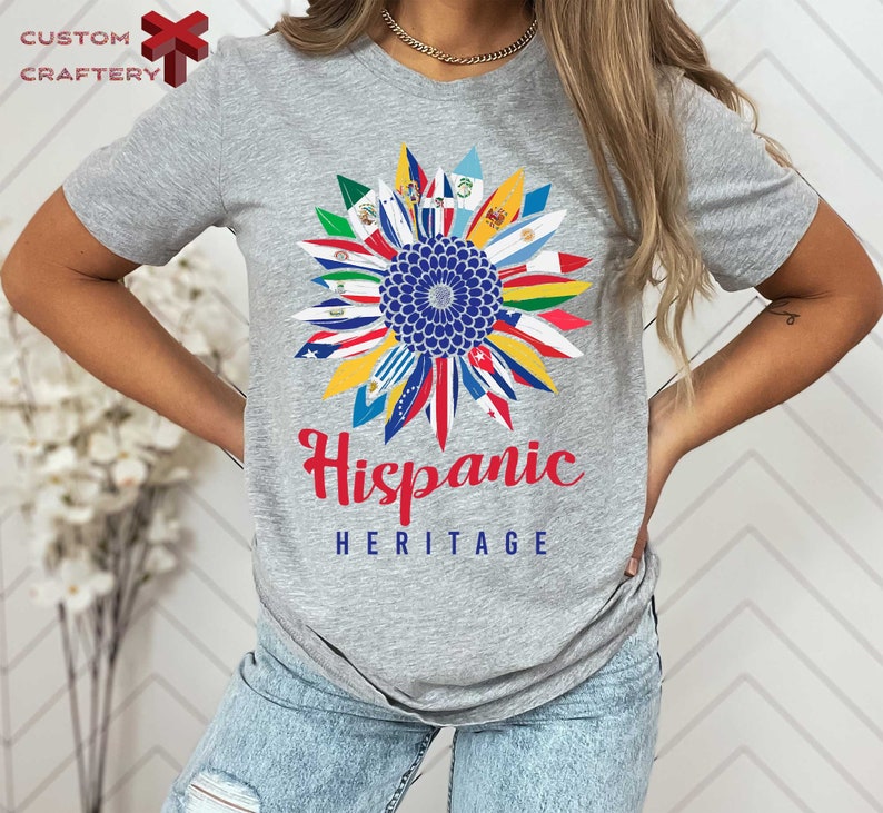 a woman wearing a gray tee shirt with the words hispanic heritage on it