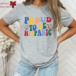 a woman wearing a t - shirt that says proud to be hispanic