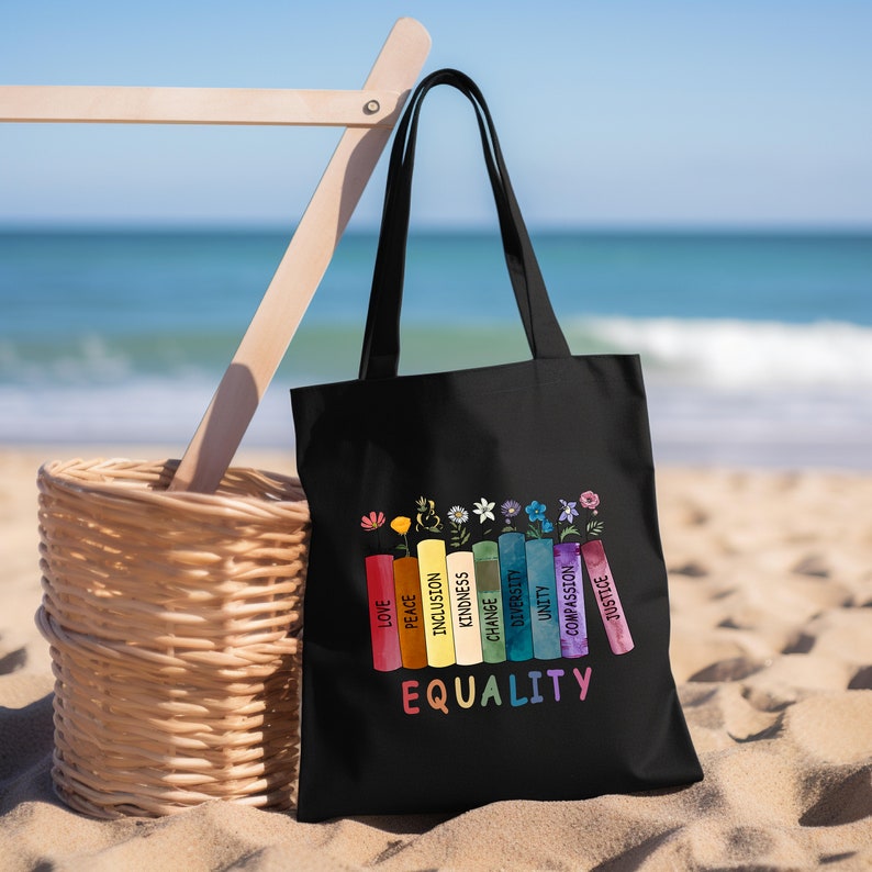 a black bag sitting on top of a sandy beach