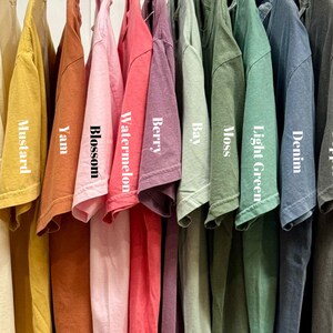 a bunch of shirts hanging on a rack