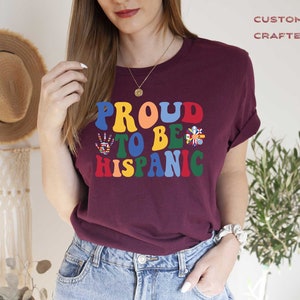 a woman wearing a t - shirt that says proud to be hispanic