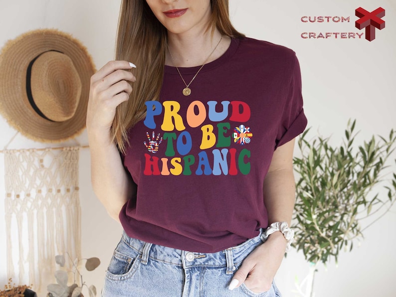 a woman wearing a t - shirt that says proud to be hispanic