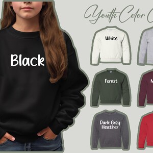May include: A black youth sweatshirt with the word "Black" in white script. The image also displays a youth color chart with sweatshirts in white, sport grey, forest green, maroon, dark grey heather, and red.