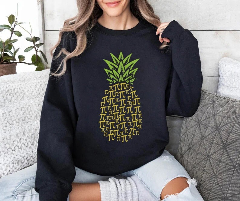 May include: Black sweatshirt with a green and yellow pineapple design. The pineapple is made up of the mathematical symbol for pi.