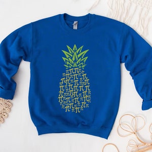 a blue sweatshirt with a yellow pineapple on it