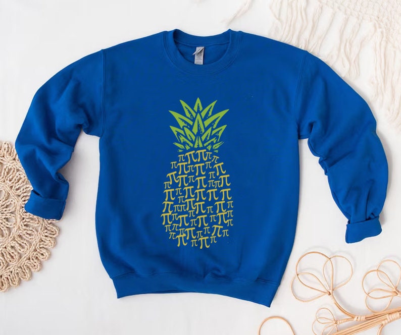 a blue sweatshirt with a yellow pineapple on it