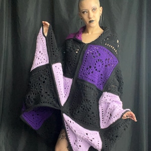 May include: A black, purple, and lavender crocheted cardigan with a zipper closure. The cardigan is made of a patchwork of different crochet squares.