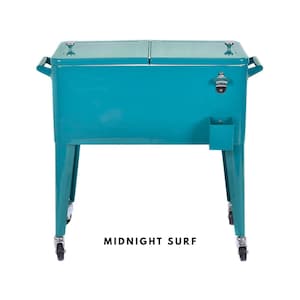 May include: A teal metal cooler with a bottle opener and a small storage compartment. The cooler has a dual-lid design, handles on the sides, and sits on four legs with wheels. The text "MIDNIGHT SURF" is printed at the bottom.