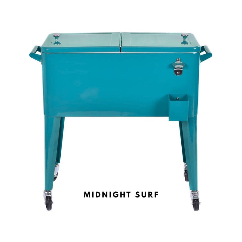 May include: A teal metal cooler with a bottle opener and a small storage compartment. The cooler has a dual-lid design, handles on the sides, and sits on four legs with wheels. The text "MIDNIGHT SURF" is printed at the bottom.