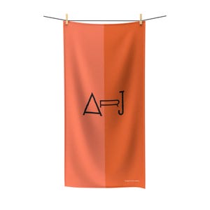 May include: A peach and orange beach towel with the letters "A-R-J" in black.