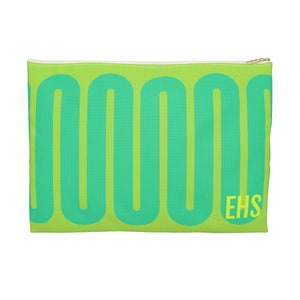 May include: A green zippered pouch with a repeating pattern of turquoise green rounded shapes. The pouch has a gold zipper and the letters "EHS" in yellow on the bottom right corner.