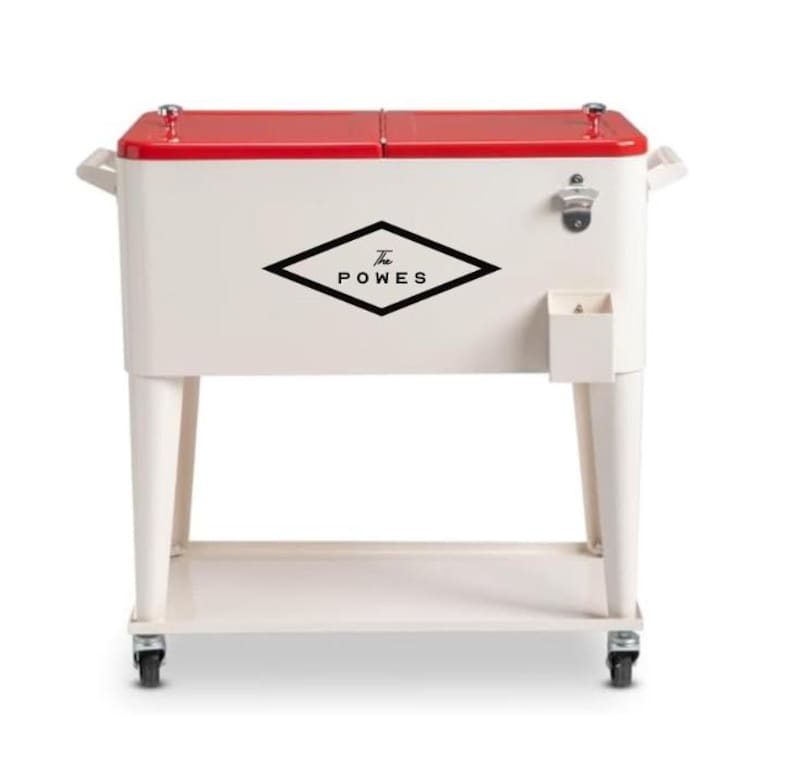 May include: A vintage-style cooler with a red lid and off-white body. It features the text "The POWES" in a black diamond shape. The cooler has a bottle opener, a small storage compartment, and sits on a rolling cart.