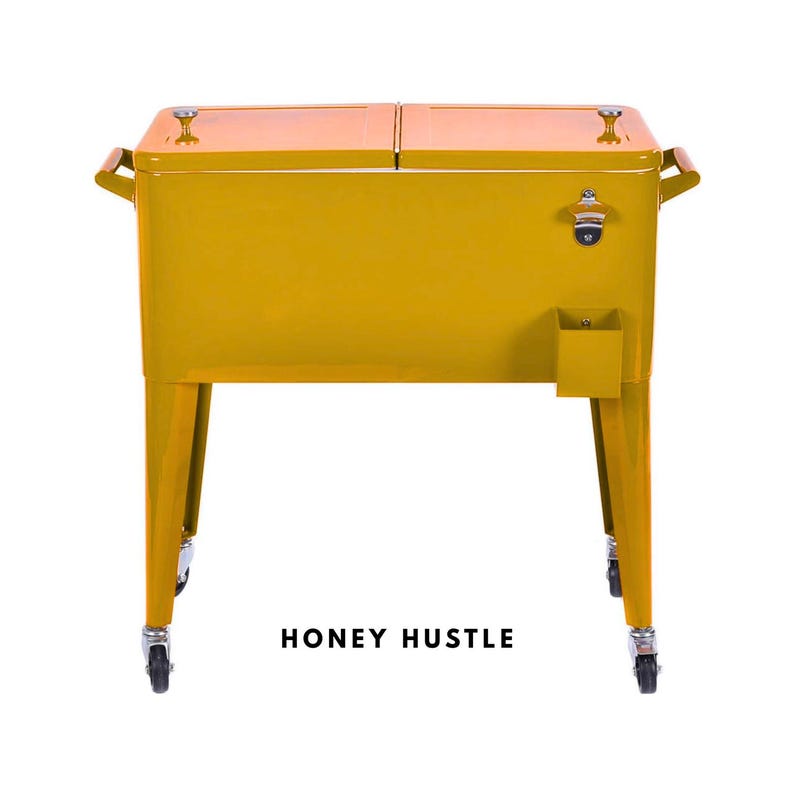 May include: A mustard yellow metal cooler with a hinged lid, wooden handles, and a built-in bottle opener. The cooler has four legs with wheels and the text "HONEY HUSTLE" at the bottom.