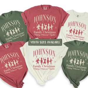 May include: A collection of six t-shirts in various colors, including green, red, and cream. Each shirt features the name "JOHNSON" above a graphic of dancing figures and the text "Family Christmas Making Memories Together". The text "YOUTH SIZES AVAILABLE" is also visible.