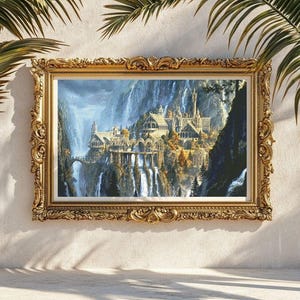 May include: A rectangular landscape painting in an ornate, antique gold-colored frame. The artwork depicts a sprawling stone castle complex nestled within a deep mountain valley, featuring multiple waterfalls, arched bridges, and autumn-toned trees.