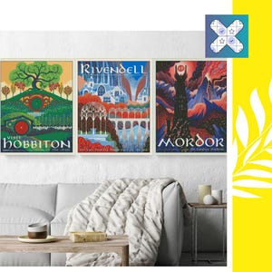 May include: Three framed travel posters with fantasy landscapes. The posters read "Visit Hobbiton", "Rivendell", and "Mordor". The posters are displayed above a white couch with a fluffy blanket. A small table with decor is next to the couch.