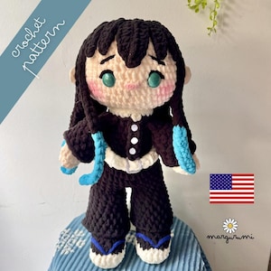 May include: A handmade crochet doll with black hair and teal eyes, wearing a black outfit with white trim and blue accents. The doll has a light skin tone and rosy cheeks. The words "crochet pattern" are written on the image.
