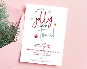 May include: A white invitation card with red and green text that reads "Let's have a jolly good time!" with event details. The card is in a pink envelope with a sprig of evergreen.