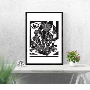 May include: Black and white print of a stylized floral arrangement in a black frame. The flowers are depicted in a bold, graphic style with intricate details.