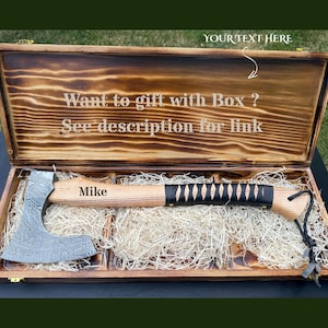 May include: A Damascus steel axe with a light wood handle, black leather wrap, and the name Mike engraved on the handle. The axe rests in a rectangular, burnt-finish wooden box with the text Want to gift with Box ? See description for link.