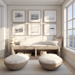 May include: A white, fluffy, round ottoman with a wooden base sits on a light wood floor in front of a white bench with a wooden top and two shelves. The bench is against a white wall with six framed black and white photos of landscapes.