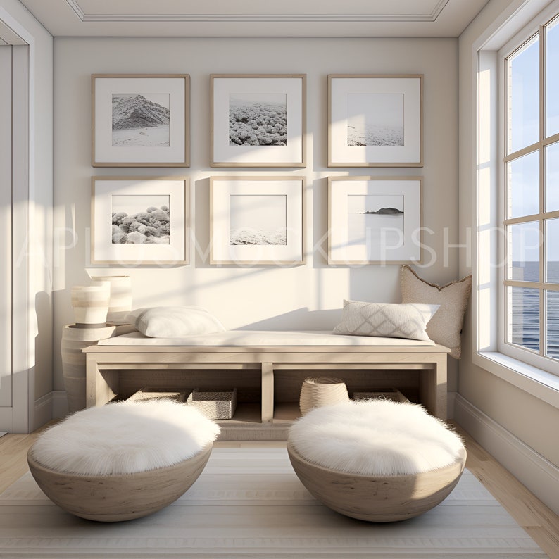 May include: A white, fluffy, round ottoman with a wooden base sits on a light wood floor in front of a white bench with a wooden top and two shelves. The bench is against a white wall with six framed black and white photos of landscapes.