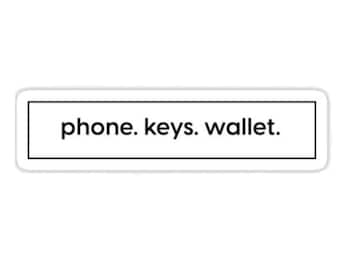 May include: A black and white sticker with the text "phone. keys. wallet." inside a black rectangle.