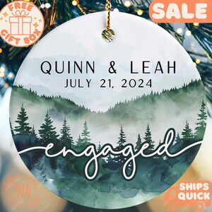 a personalized ornament hanging from a christmas tree