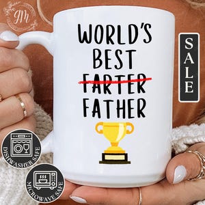 May include: White ceramic mug with a black and red design that says "World's Best Farter Father" with a red line through "Farter". A gold trophy icon is below the text. The mug is dishwasher and microwave safe.