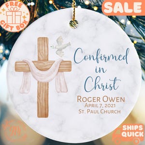 a ceramic ornament hanging from a christmas tree