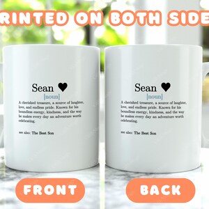 two white coffee mugs sitting on top of a table