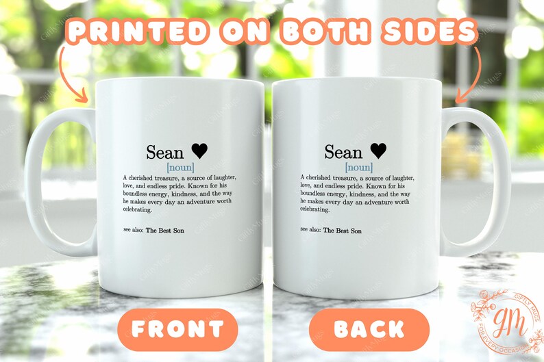 two white coffee mugs sitting on top of a table