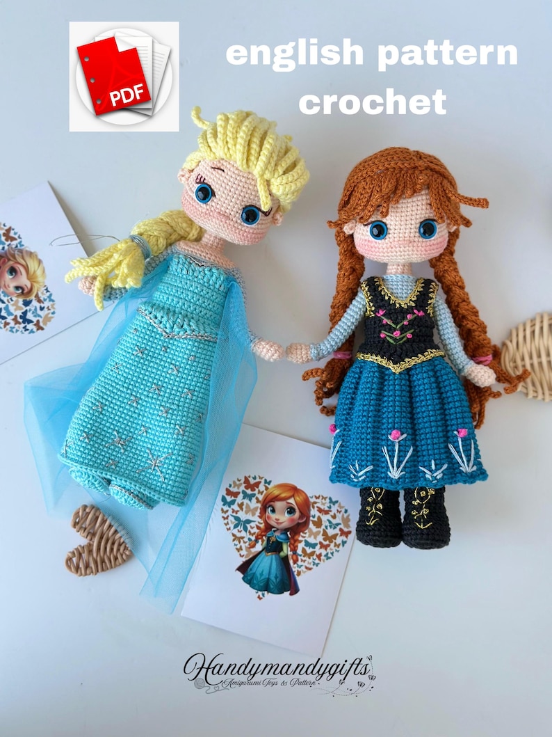 May include: Two crocheted dolls, one with blonde hair and a blue dress, the other with red hair and a blue dress, stand side-by-side. The words "english pattern crochet" are above the dolls. The dolls are holding hands. A PDF icon is in the upper left corner.