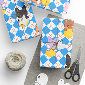 May include: Gift-wrapped presents with blue and white diamond pattern paper, tied with twine and adorned with wooden star and heart tags. The paper features cartoon animal illustrations. A ball of twine, scissors, and blank tags are also present.