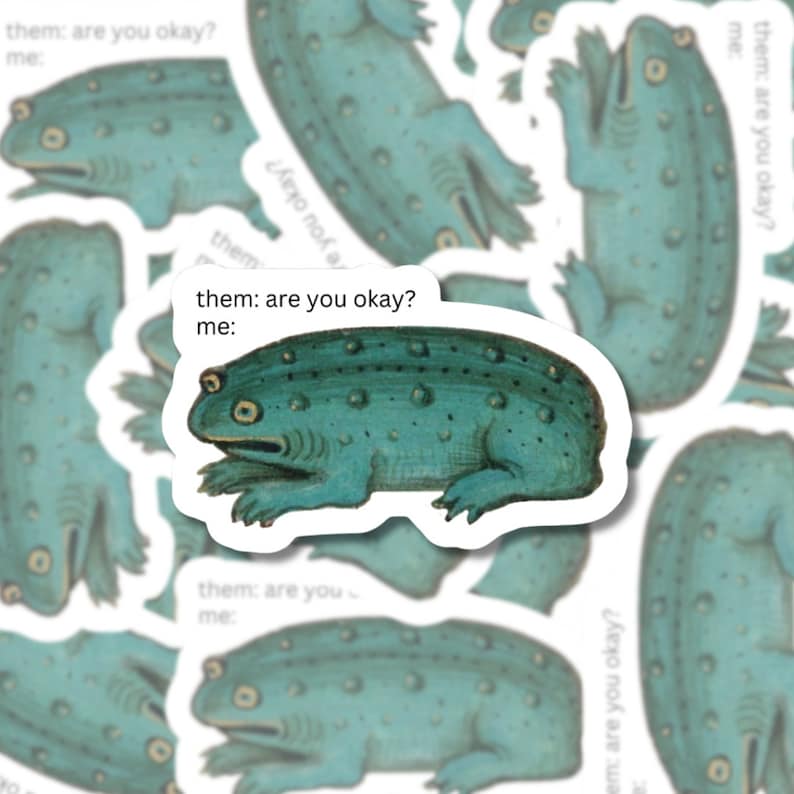Die-cut matte vinyl sticker featuring a green frog with the text 'Them: Are you okay? Me:' inspired by medieval marginalia.