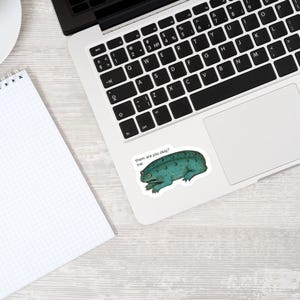 Frog sticker displayed on a laptop, showcasing its unique medieval-inspired design