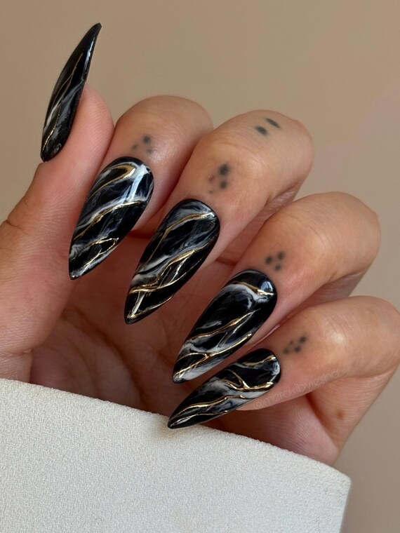 Black and white marble nails with gold accents