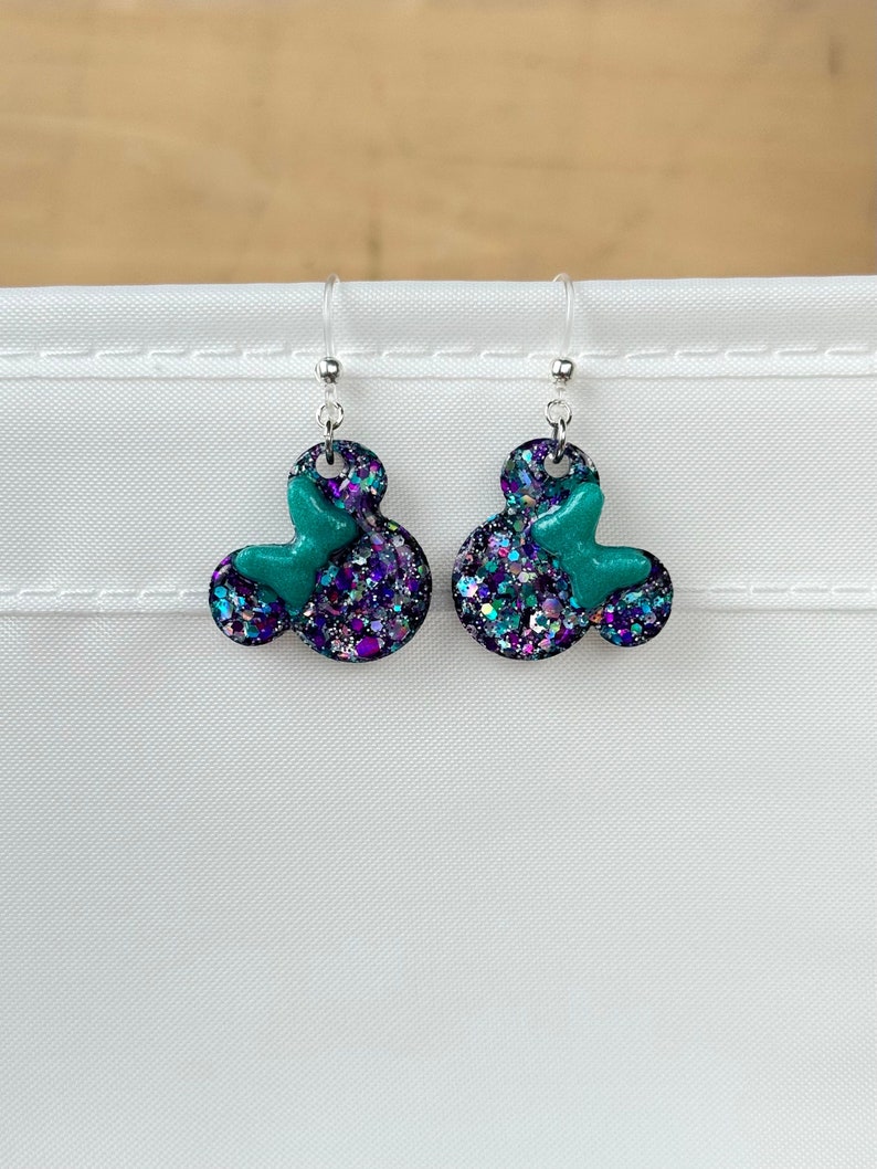 mickey head earrings, Minnie Mouse earrings - resin mouse heads filled with purple/silver/teal holographic glitter with matching pearlescent teal bow