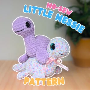 May include: Two crocheted Nessie dolls, one lavender and one pastel-colored, are stacked. The lavender Nessie sits atop the pastel Nessie, which has a pink ribbon. The image includes the text "NO-SEW LITTLE NESSIE PATTERN."