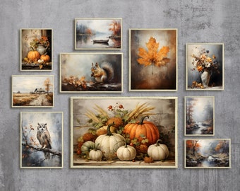 May include: A collection of framed fall-themed artwork featuring pumpkins, squirrels, owls, leaves, and landscapes. The artwork is displayed on a gray wall.