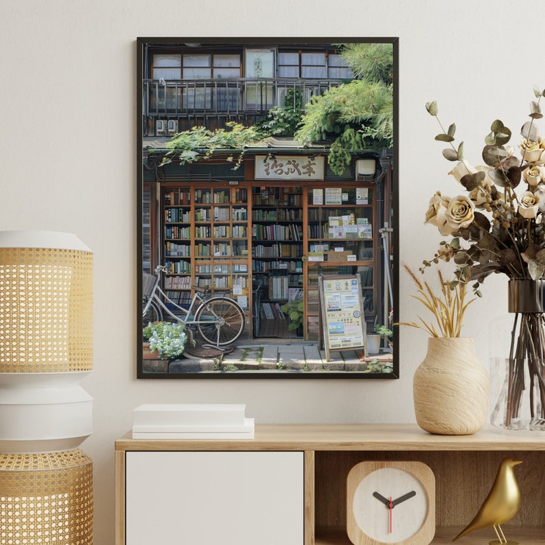 May include: A black framed photograph of a bookstore in Japan. The storefront is lined with bookshelves filled with books. The shop is called "谷沢本" and there is a bicycle parked in front of the store.