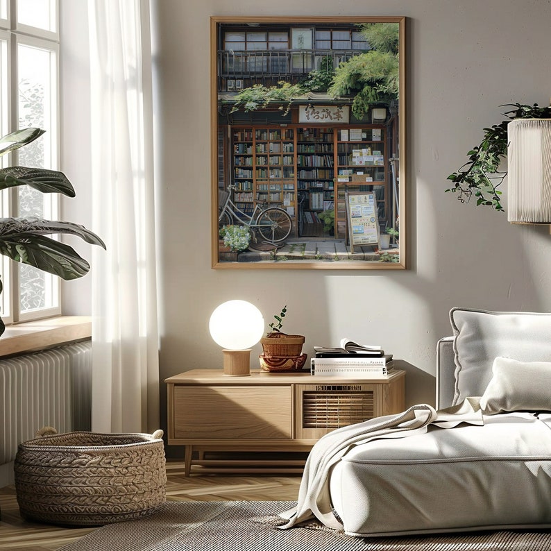 May include: A framed photograph of a bookstore in Japan with a bicycle parked in front. The bookstore has a wooden facade and a sign that reads "Honya". The photograph is hanging on a white wall in a living room setting.