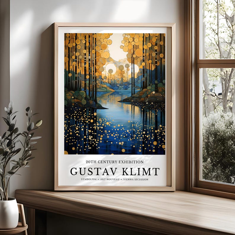 May include: A framed art print featuring a landscape painting in the style of Gustav Klimt. The artwork depicts a forest scene with a body of water, rendered in shades of blue, gold, and green. Text at the bottom reads "20TH CENTURY EXHIBITION GUSTAV KLIMT".