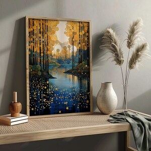 May include: A framed print of a stylized landscape with a blue lake and golden trees. The trees are made up of circles and the lake reflects the trees. The print is on a wooden table with a vase and dried flowers.