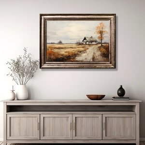May include: A framed oil painting depicting a rural landscape with a small white house and a dirt road leading to it. The house is surrounded by trees and fields, and the sky is cloudy. The painting is framed in a silver frame.